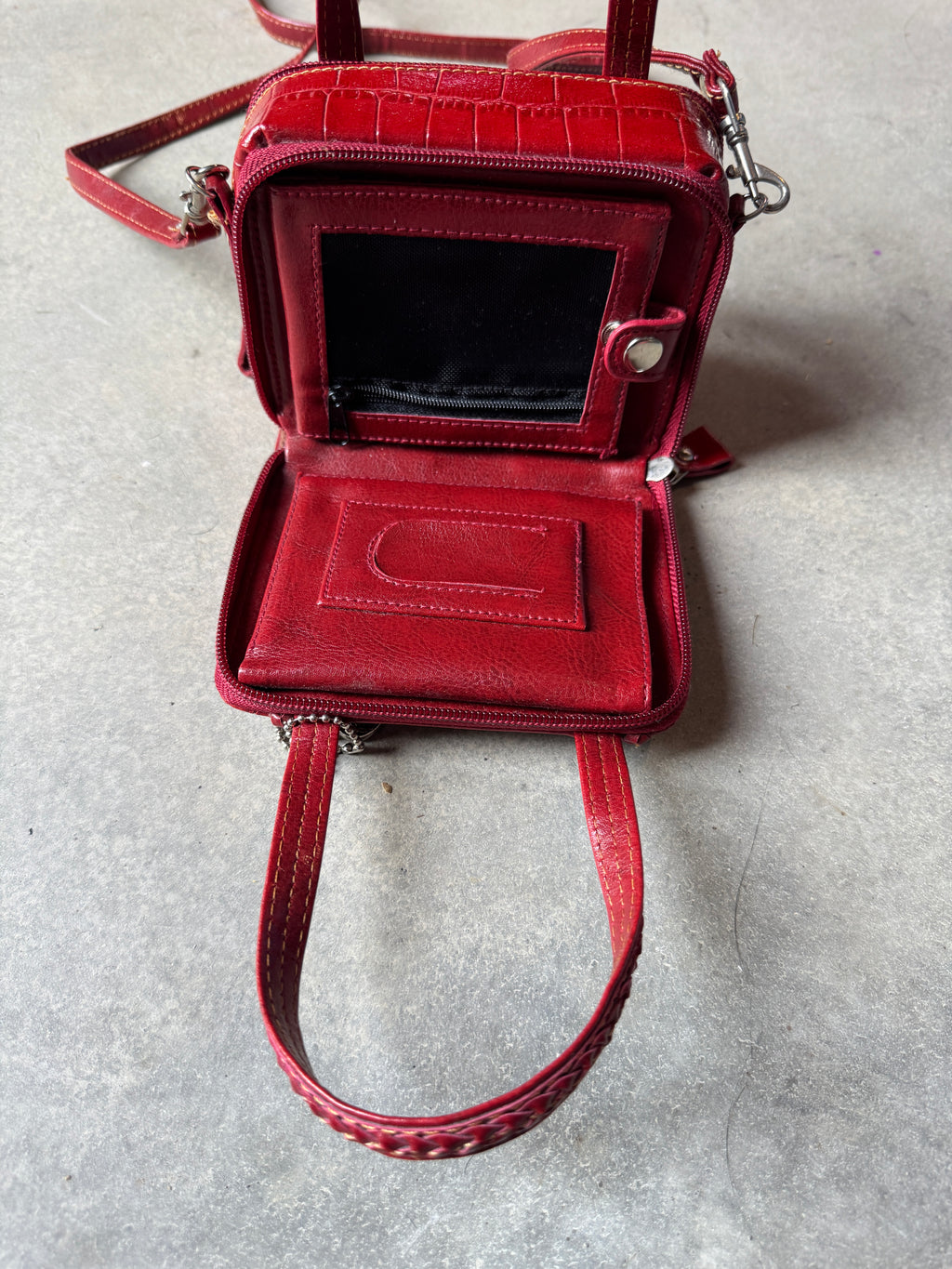 Red handbag on a gray textured surface