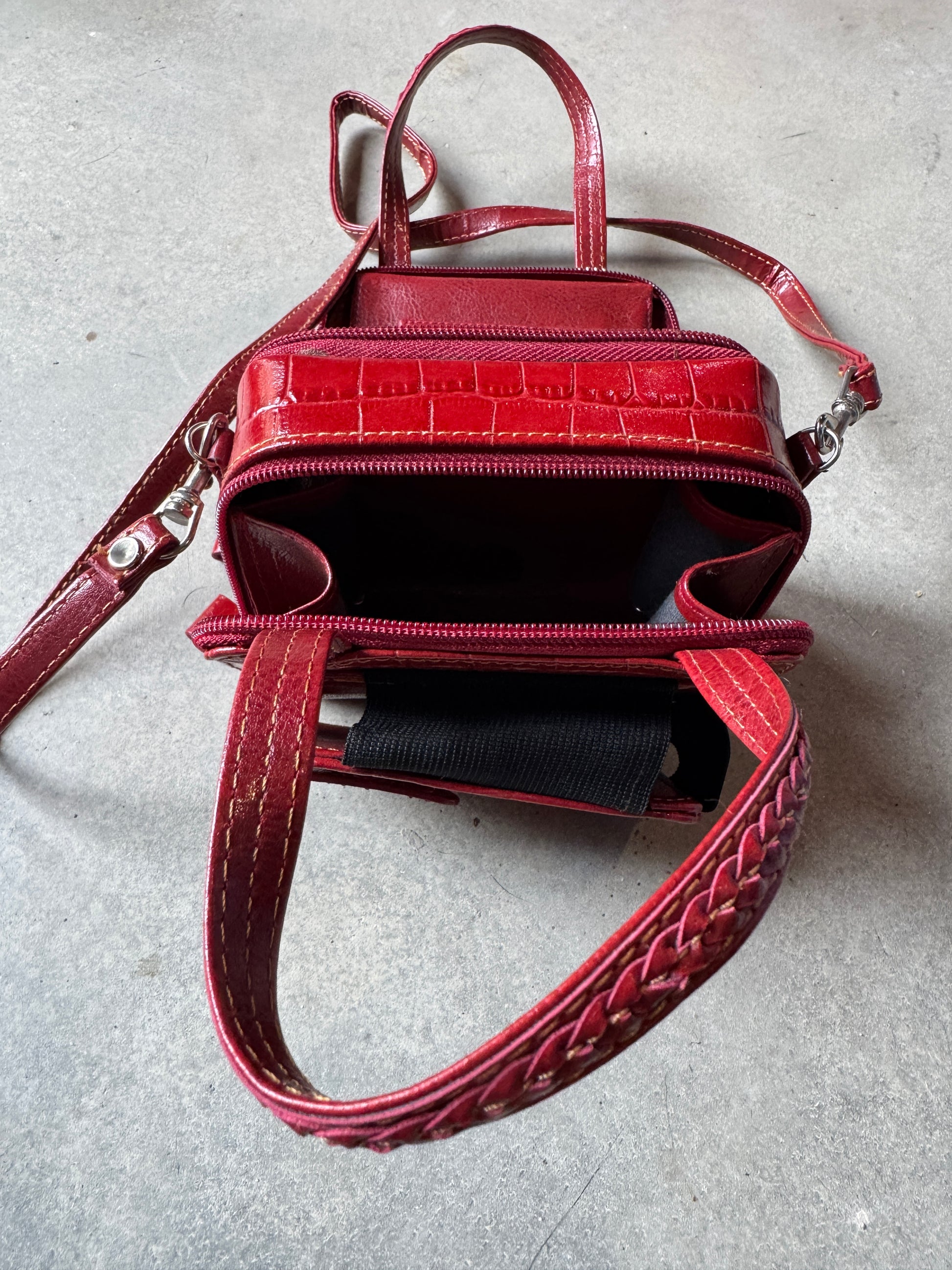 Red textured handbag on a light gray surface