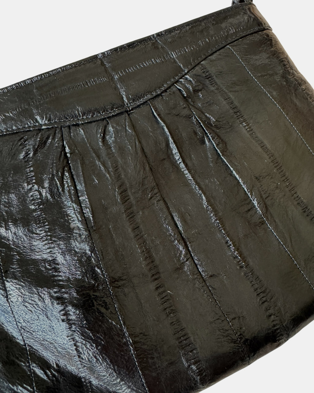 Highway Robbery Vintage black genuine eel skin shoulder bag with a glossy, textured finish and pleated detail.