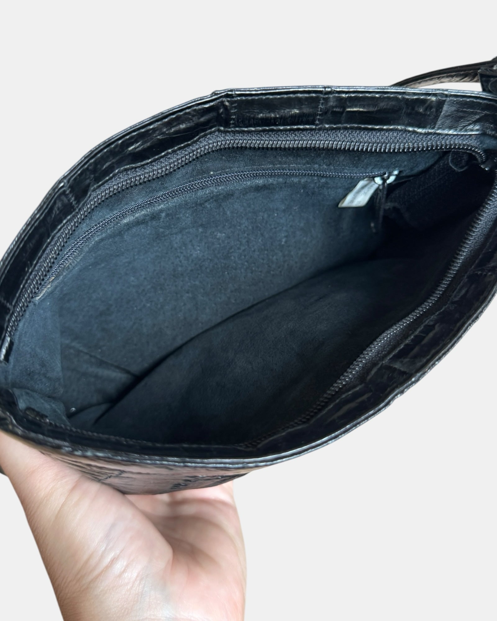 Highway Robbery Vintage black genuine eel skin shoulder bag interior featuring a secure zippered main compartment