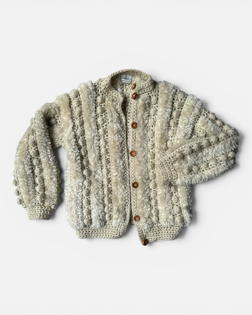Highway Robbery Vintage cream crochet cardigan with textured bobble stitch panels and rustic wooden buttons.